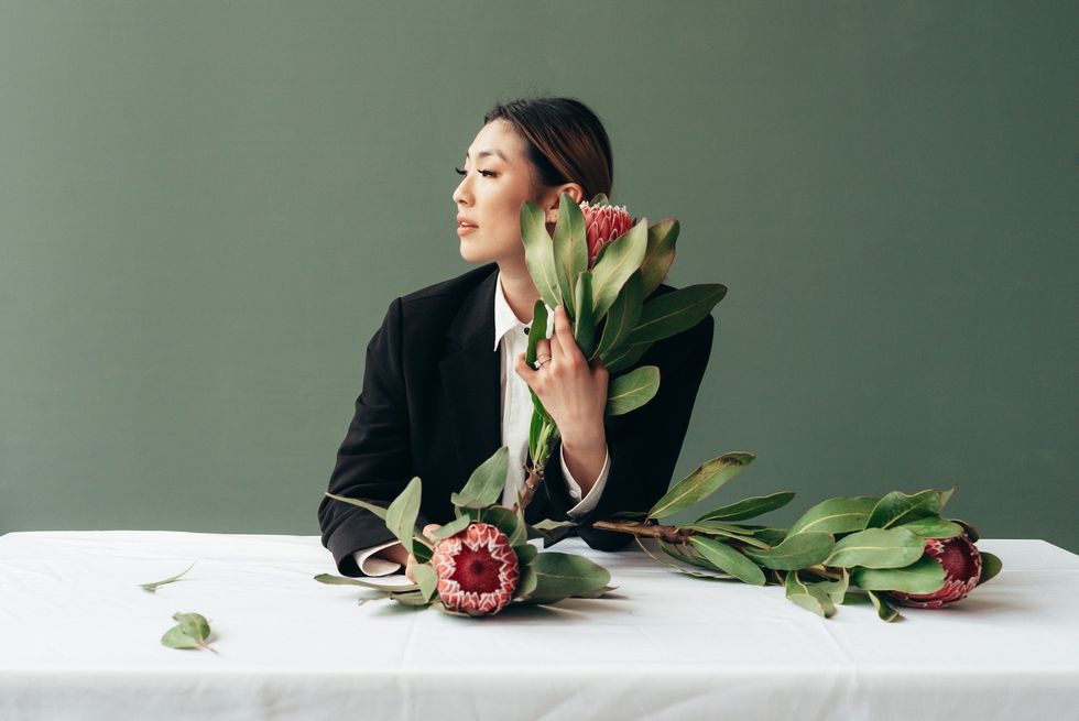 woman sitting at a table with flowers imaginary relationship