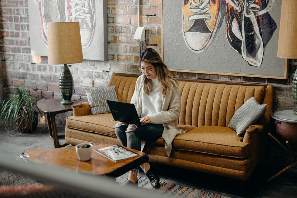 woman sitting on a couch to do work