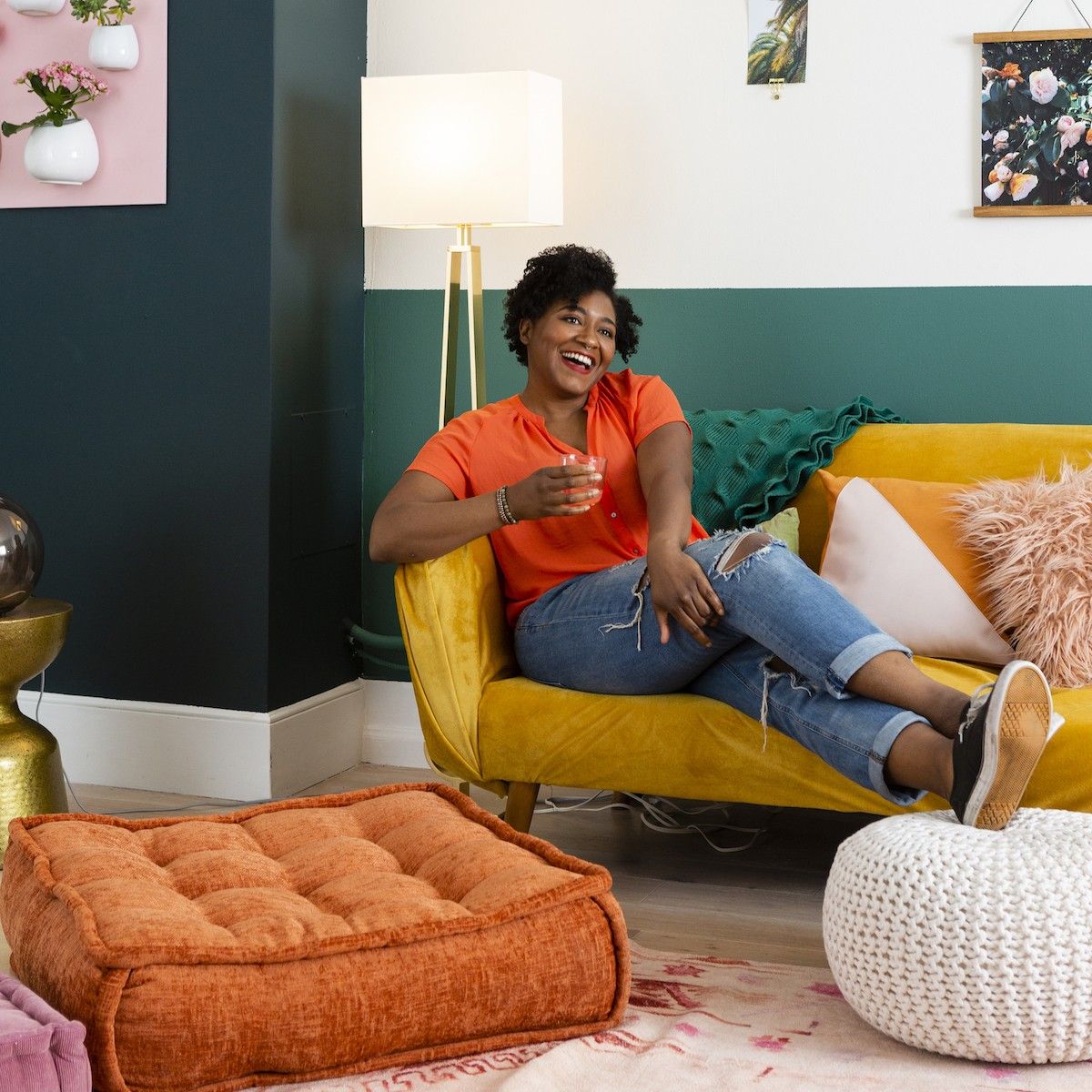 woman sitting on her couch with a drink how to reduce your electric bill