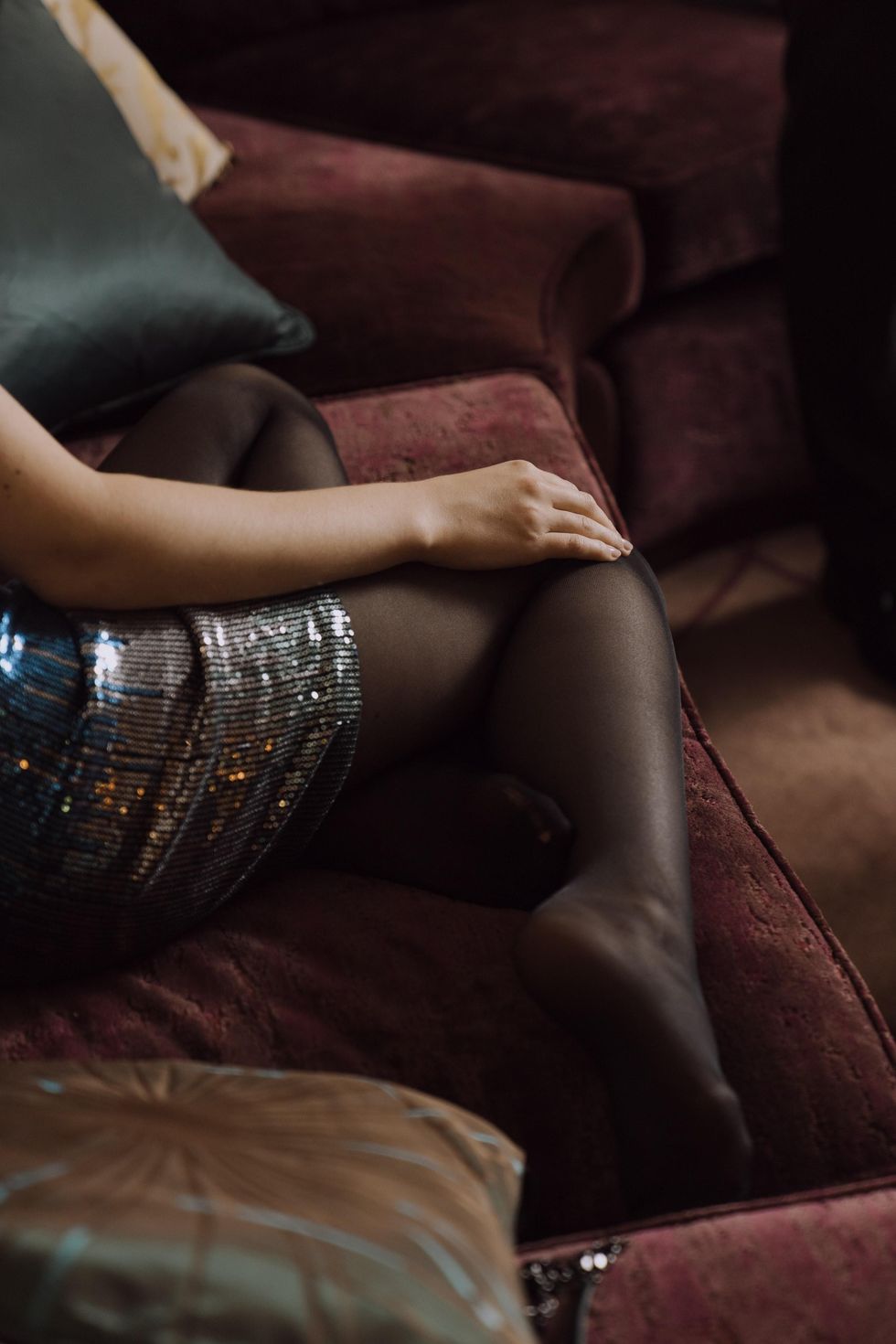 woman sitting on the couch with tights commando