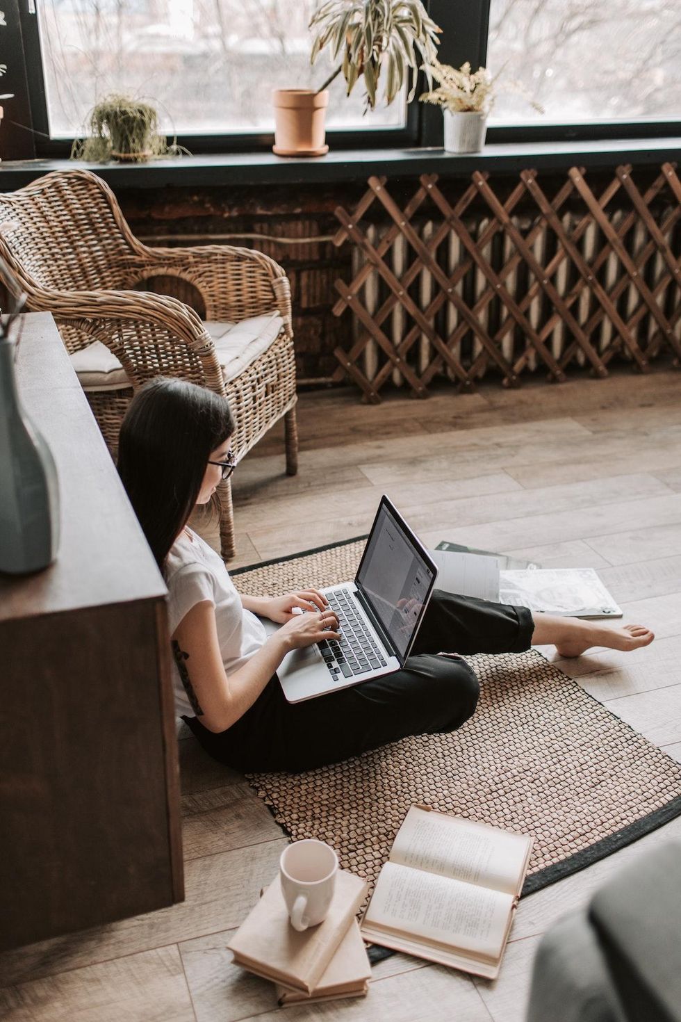woman sitting on the floor typing NaNoWriMo