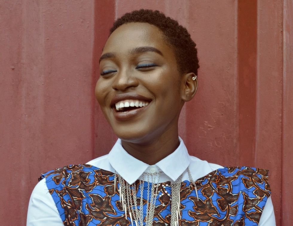 woman smiling against a red background