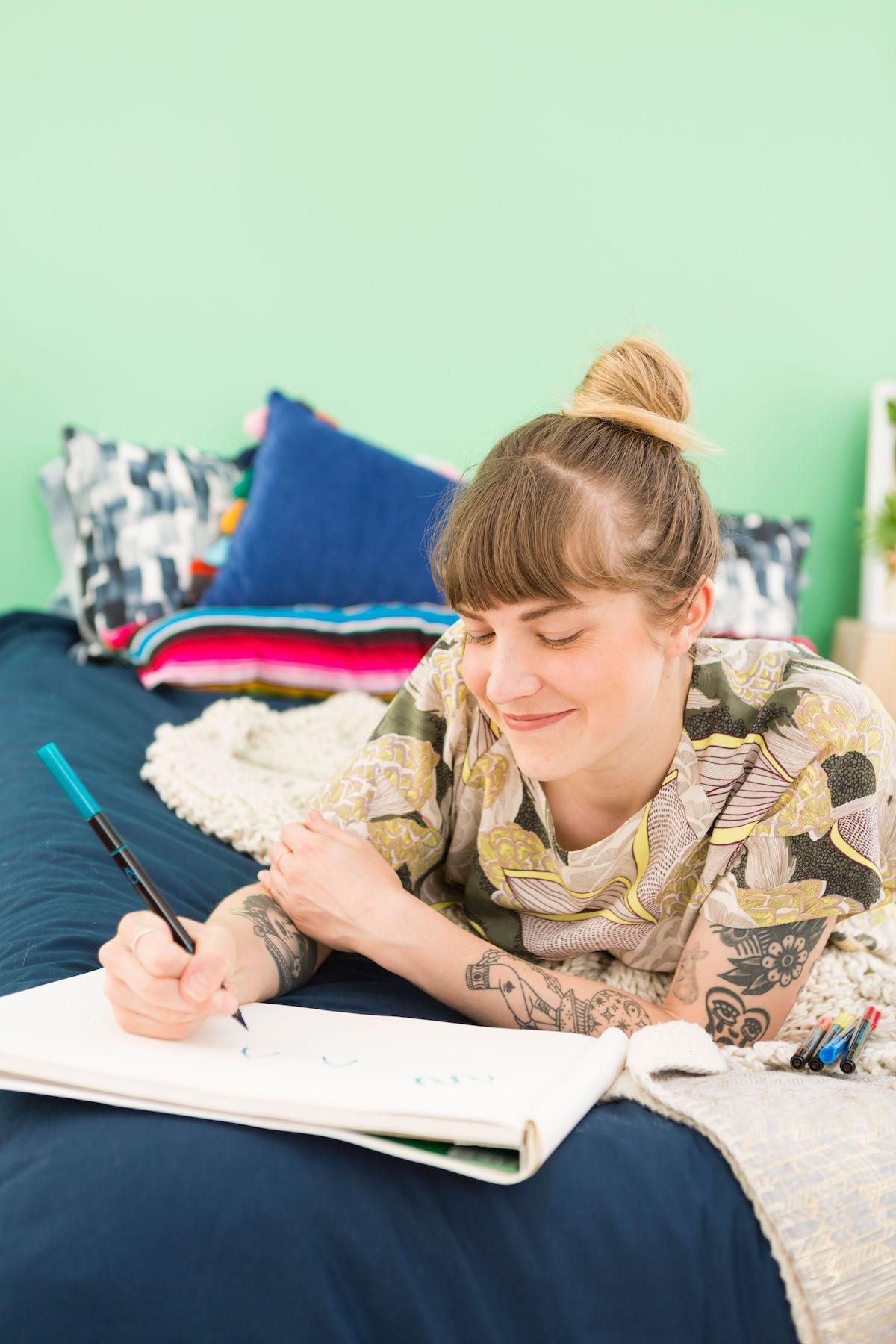 woman smiling and journaling