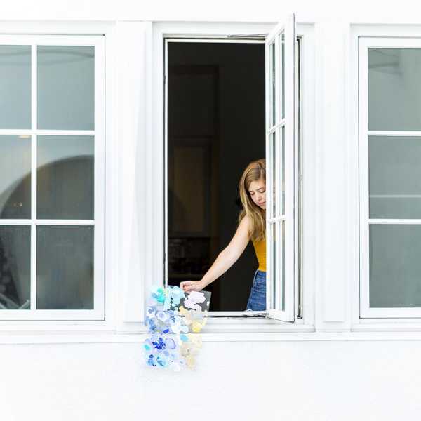 woman standing at an open window