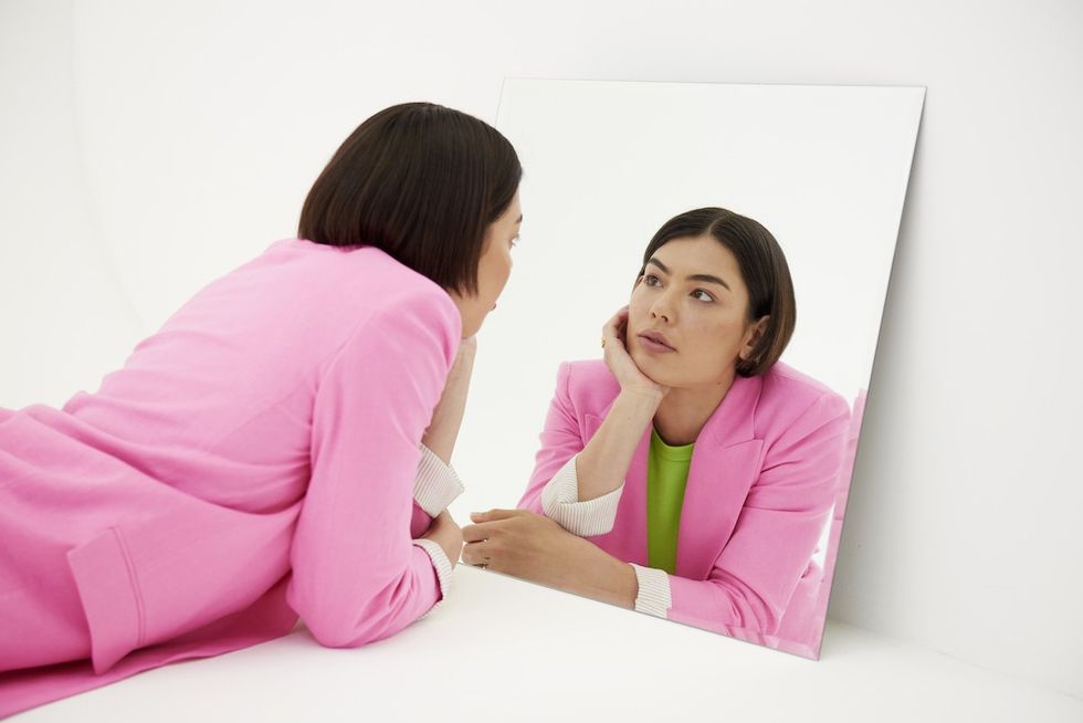 woman starring at her reflection