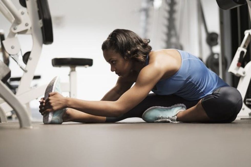 woman stretching at gym