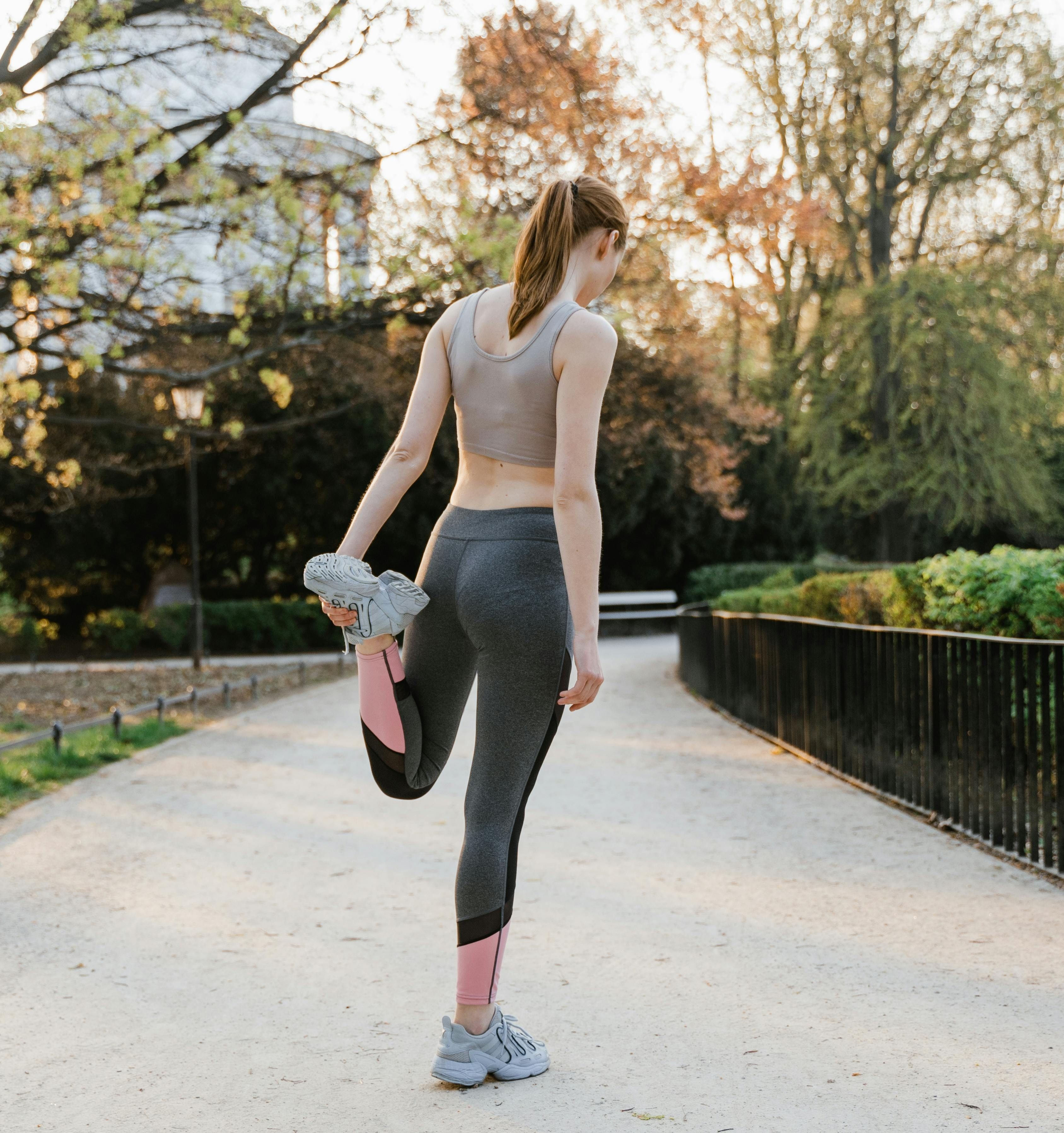 woman stretching before a run in the park
