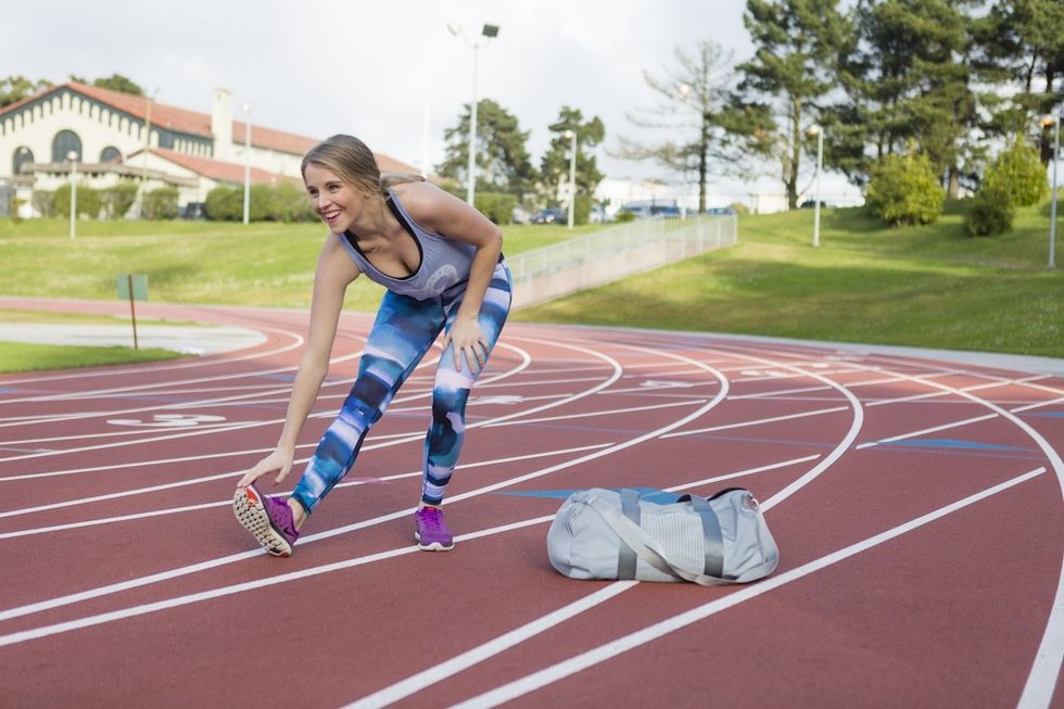 woman stretching on a track how to stay flexible