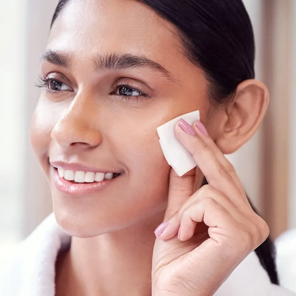 Woman using Lancer Gentle Exfoliating Peel Pads