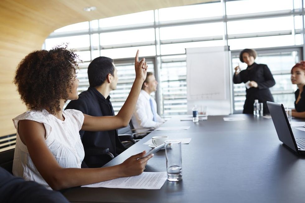 Woman volunteering at work meeting