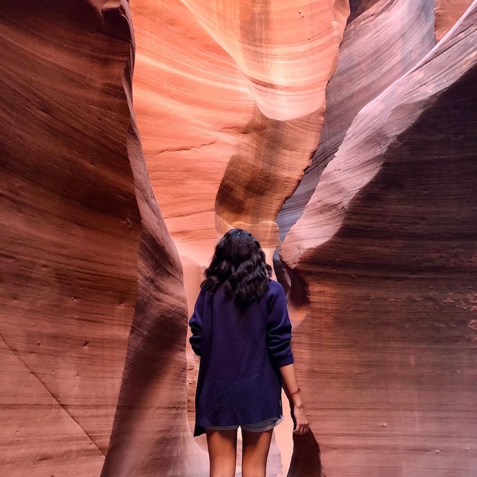 woman walking around antelope canyon