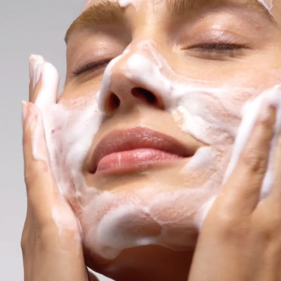 woman washing face with Caudalie Gentle Foam Cleanser