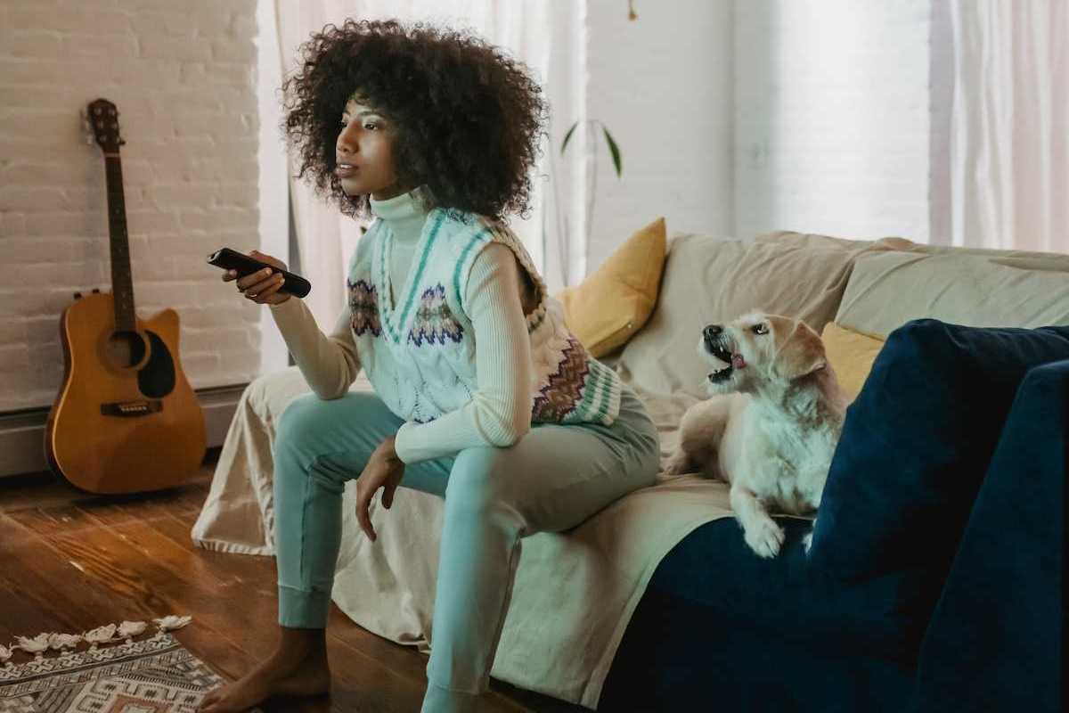 woman watching tv on her couch