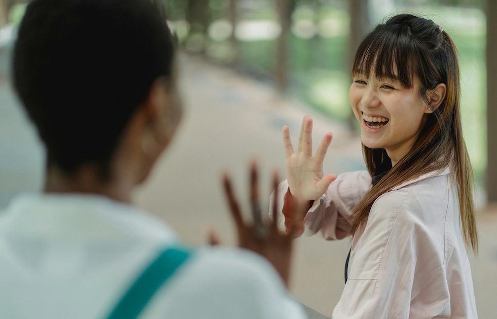 woman waving to her neighbor