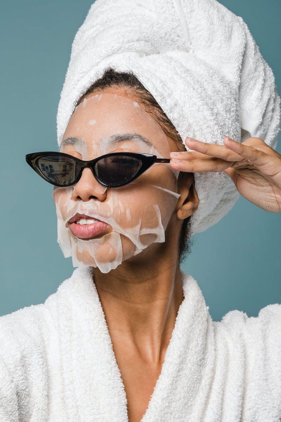 Woman with a face mask and sunglasses