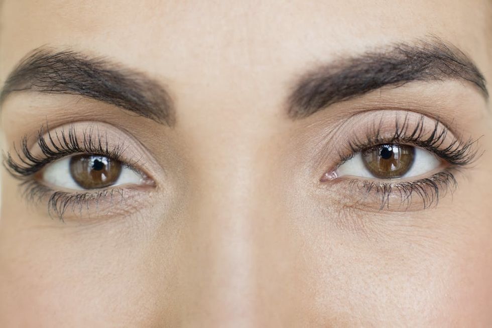 Woman with brown eyes and long lashes.