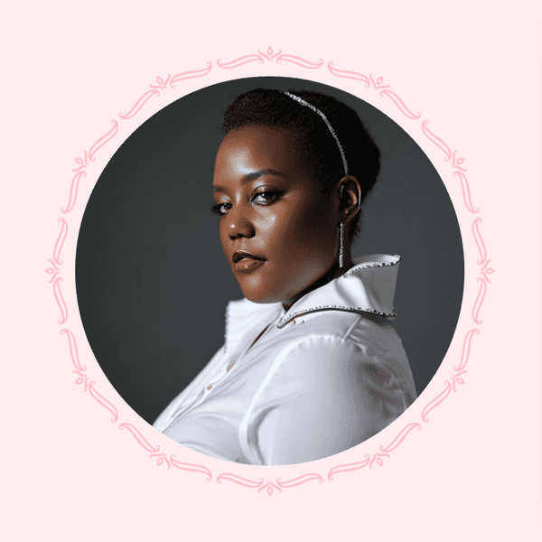 Woman with elegant updo and white blouse, framed by pink ornamental border.