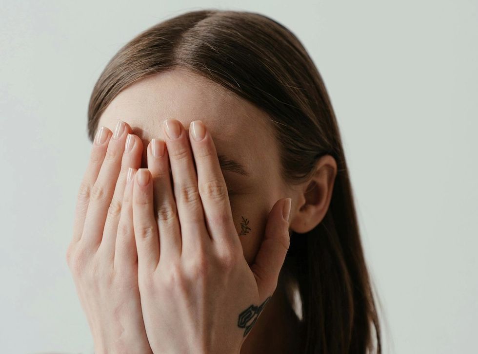 woman with her face in her hands