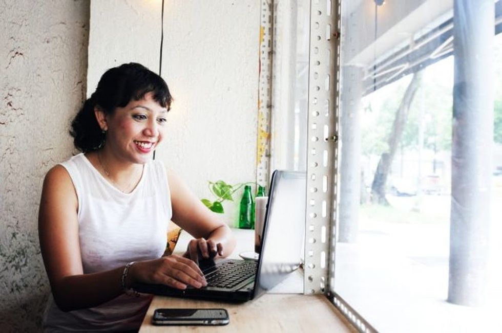 Woman working in front of a coffee shop window
