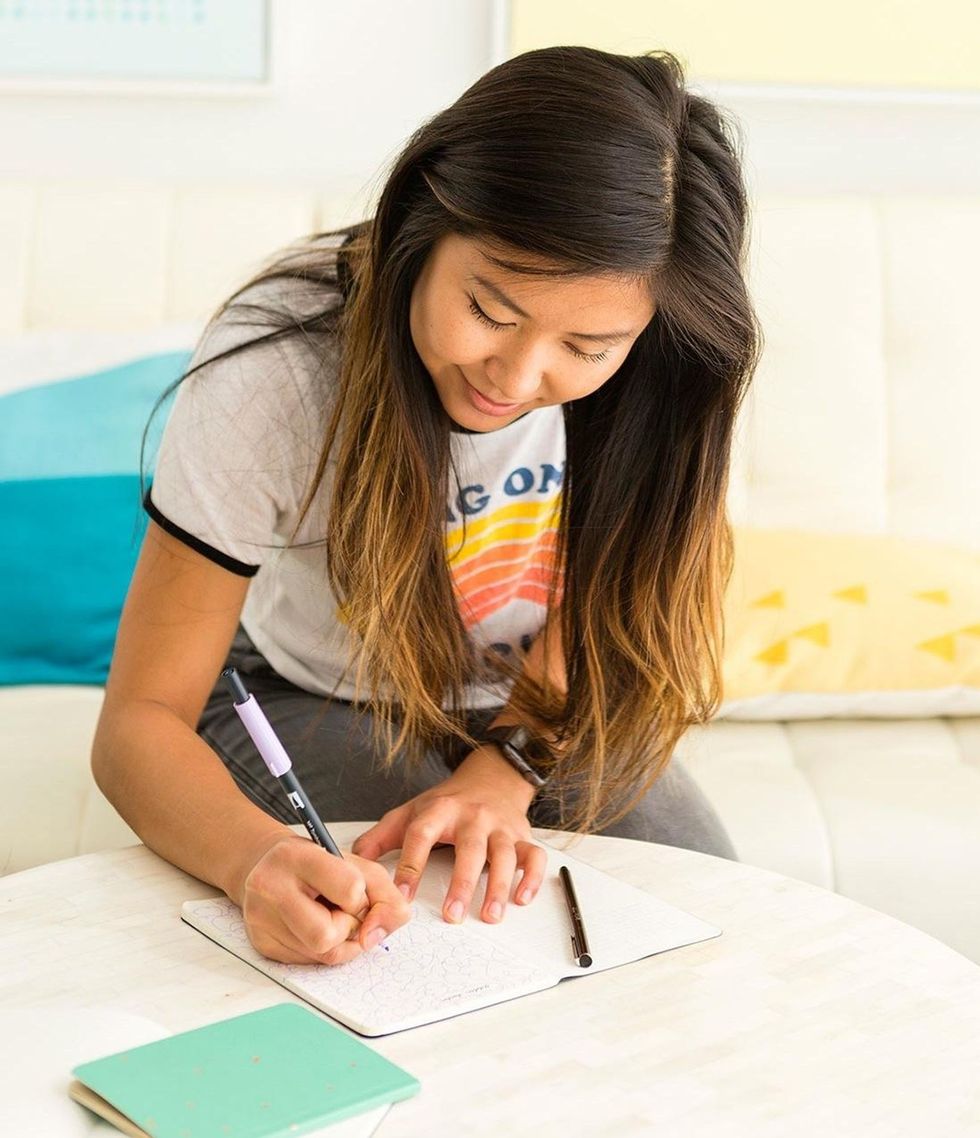 woman writing in her bullet journal