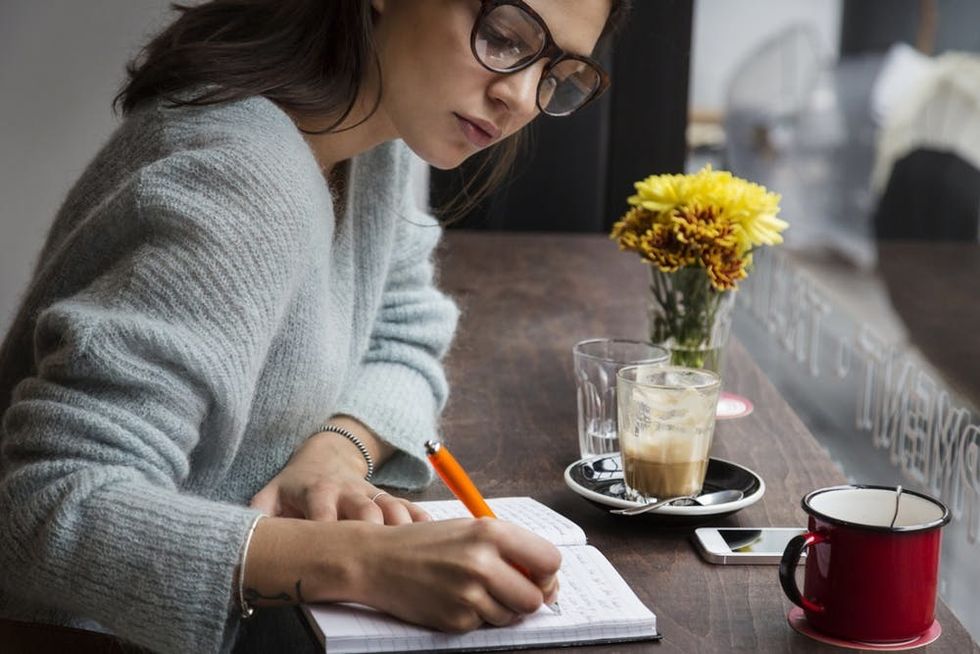 Woman writing in journal