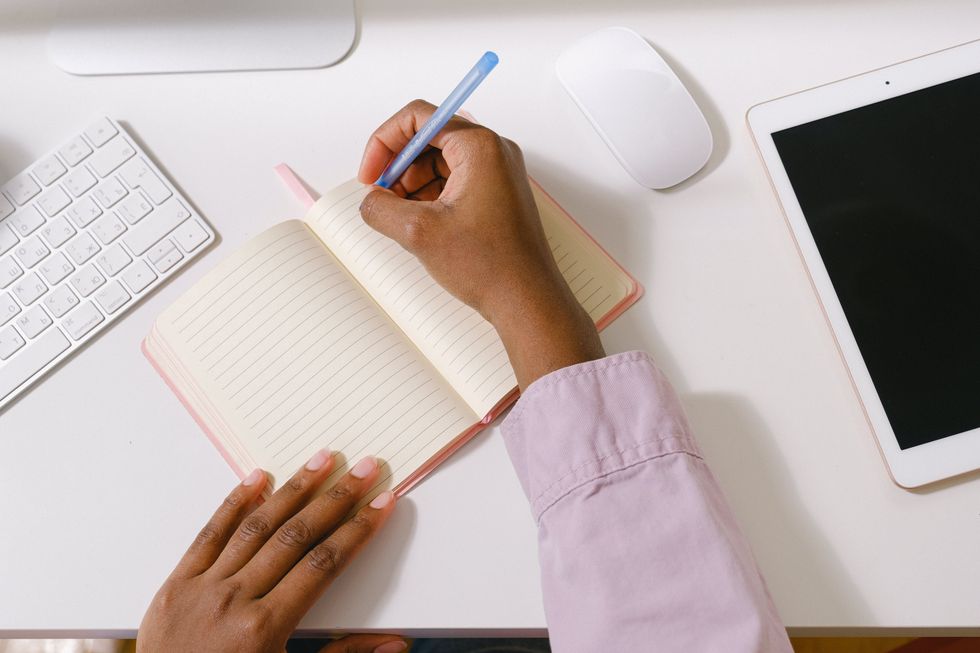 woman writing in notebook