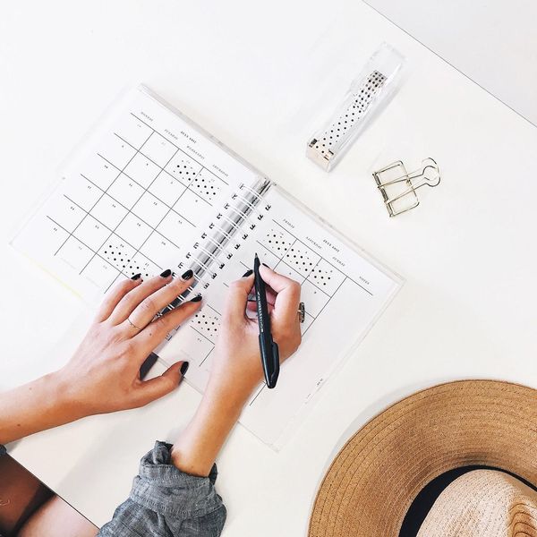 woman writing in planner