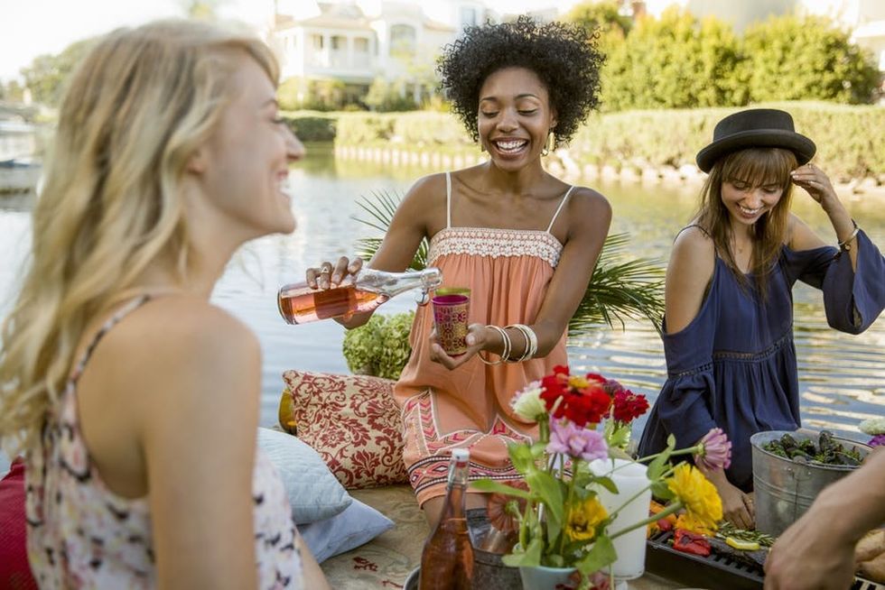 Women drinking ros\u00e9 at a picnic