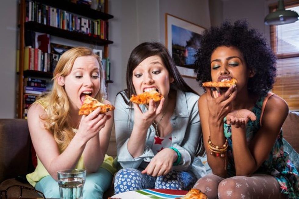 women eating pizza