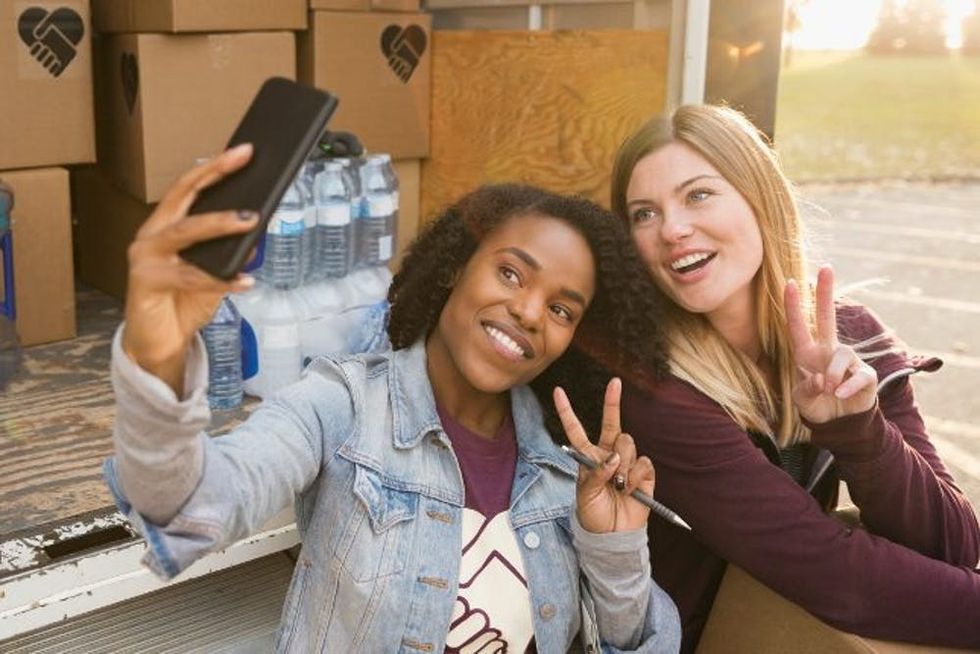 women giving peace sign for camera