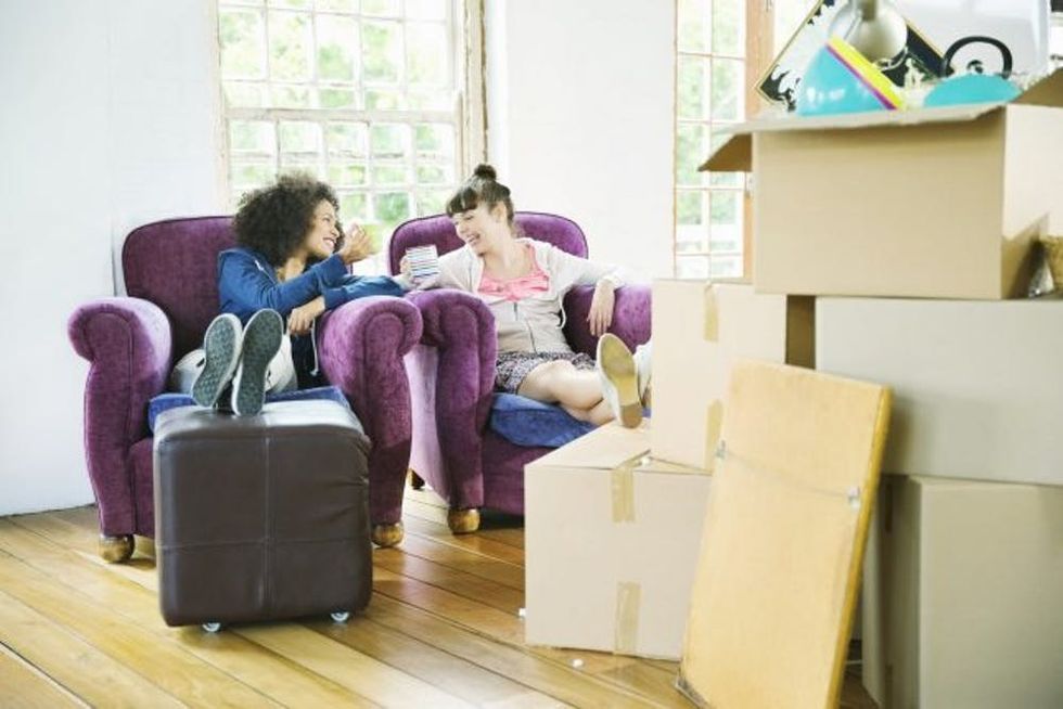 Women having coffee together in new home