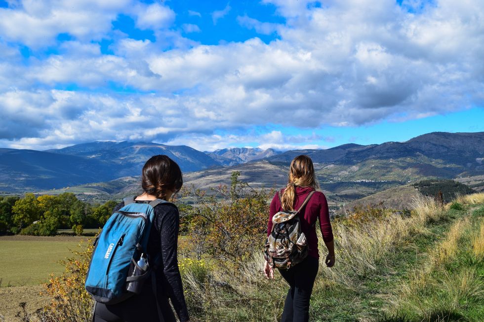 women hiking along trail