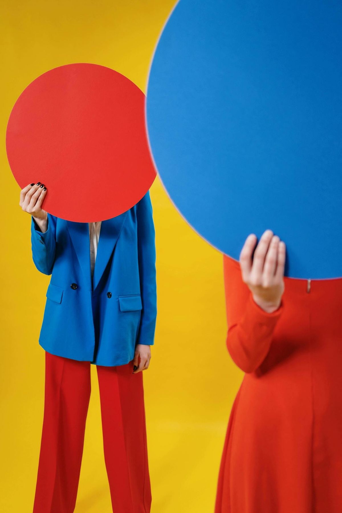 women in red pantsuit with blue blazer primary colors