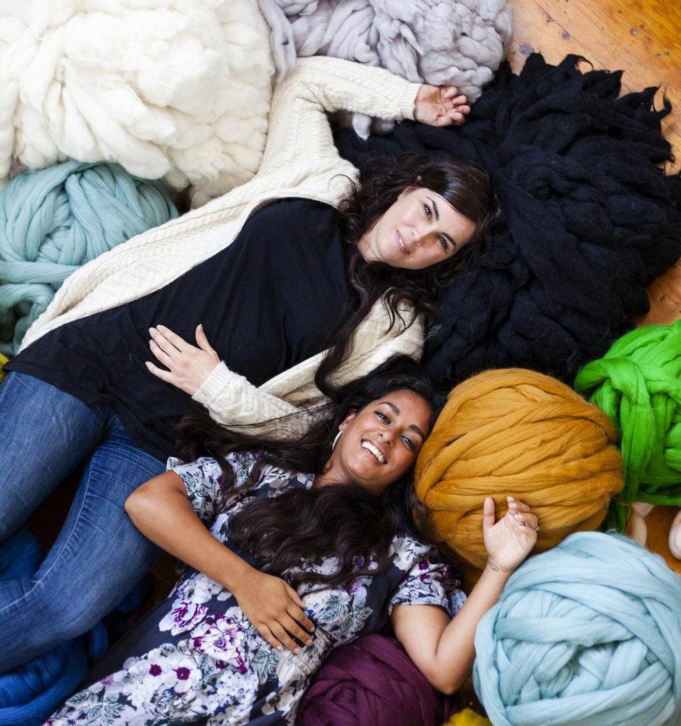 women laying in a pile of yarn