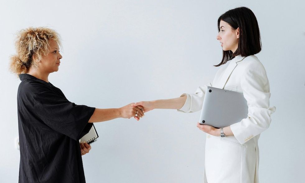 women shaking hands at work