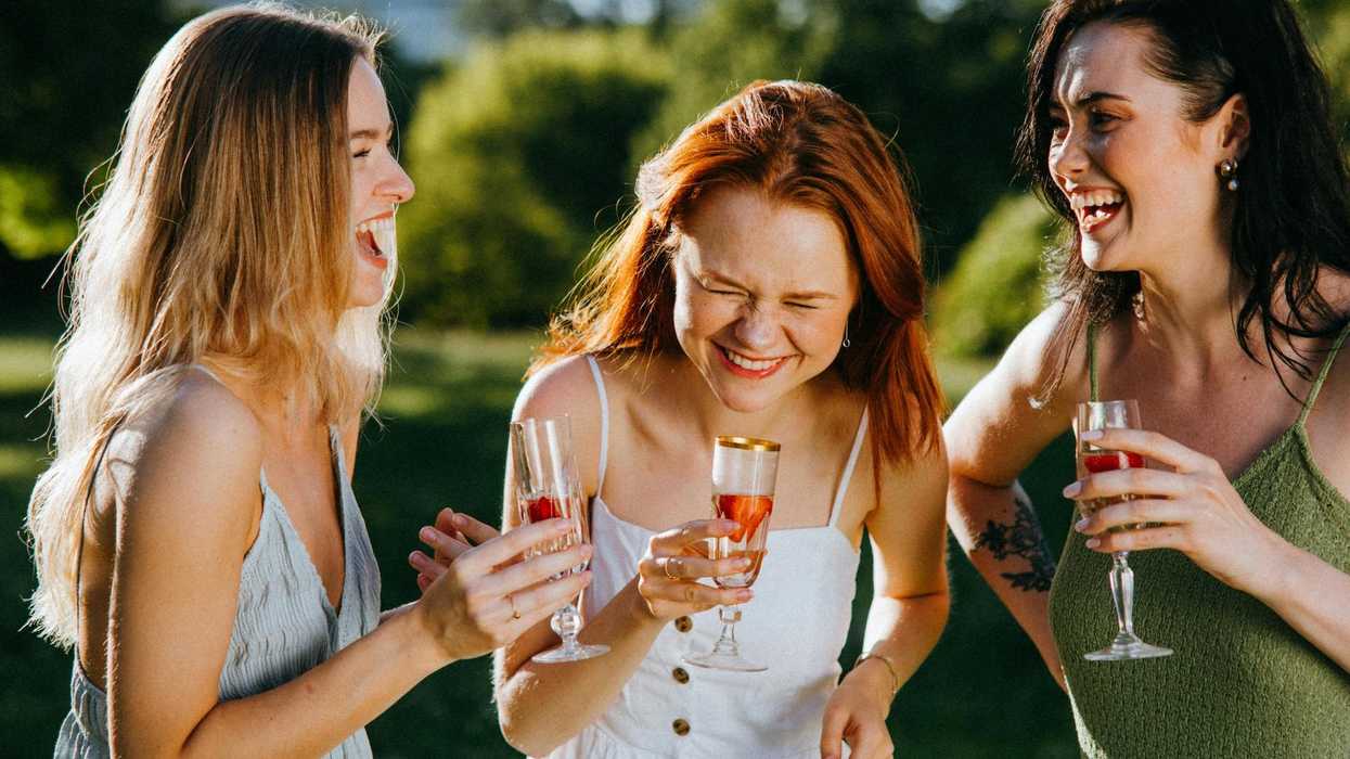 women sipping wine laughing