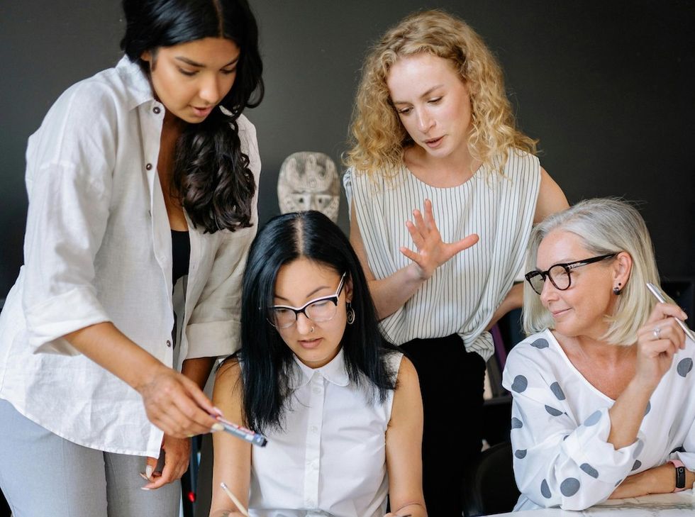 women working on a project at work together