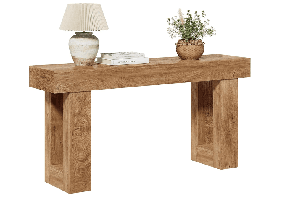 Wooden console table with a lamp, books, and a potted plant.