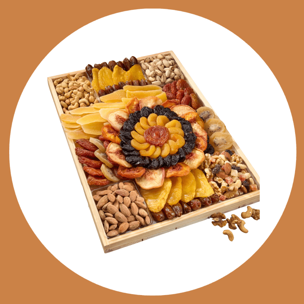 Wooden tray with assorted dried fruits and nuts in a decorative arrangement.
