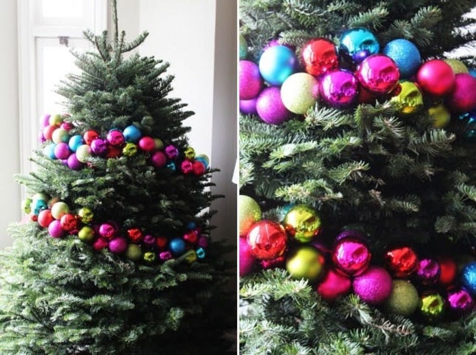 wrapping the tree in a strand of ornaments