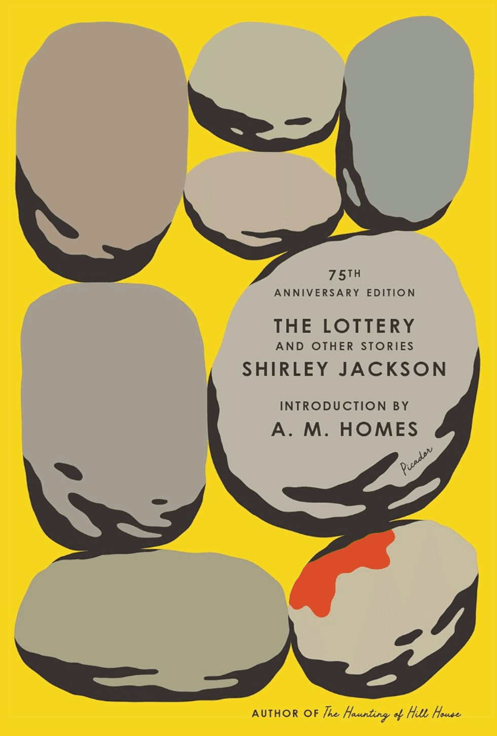 Yellow book cover with gray stones, one with a red mark. "The Lottery" by Shirley Jackson.
