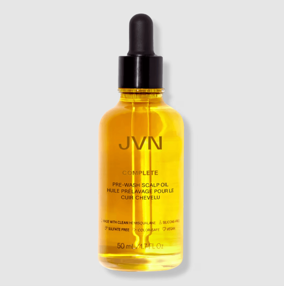 Yellow bottle of JVN Pre-Wash Scalp Oil with dropper cap on gray background.