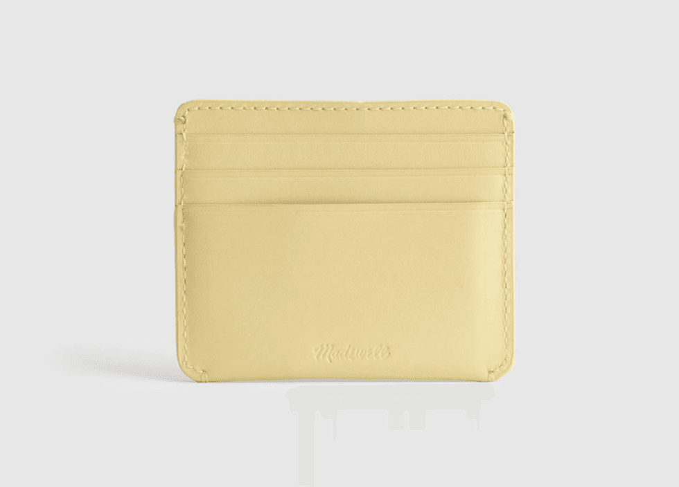 Yellow leather card holder with multiple slots on a white background.