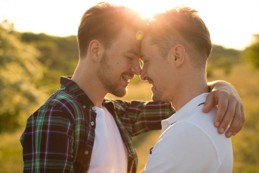 Young-gay-couple-in-a-meadow-000064829323_Medium