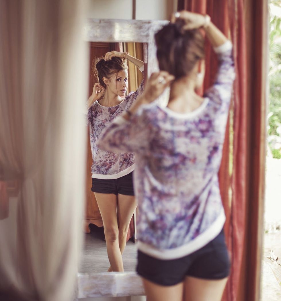 Young woman at home near the mirror