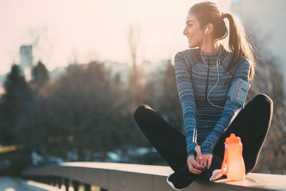 Young woman resting after the jogging in the city.