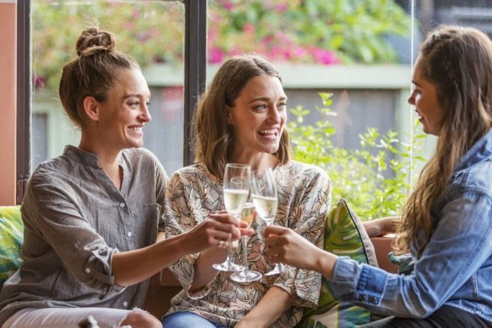 Young Women Celebrating With Champage in a Bar
