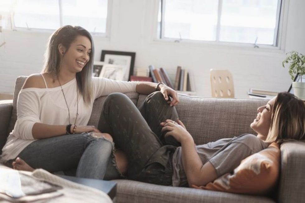 Young women talking on sofa