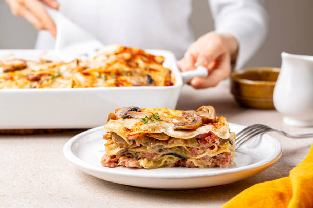https://www.brit.co/reviews/wp-content/uploads/2023/11/serving-cooking-homemade-white-lasagna-with-porcini-and-champignon-mushrooms-onion-and-meat-channel-576-article-232215.jpg