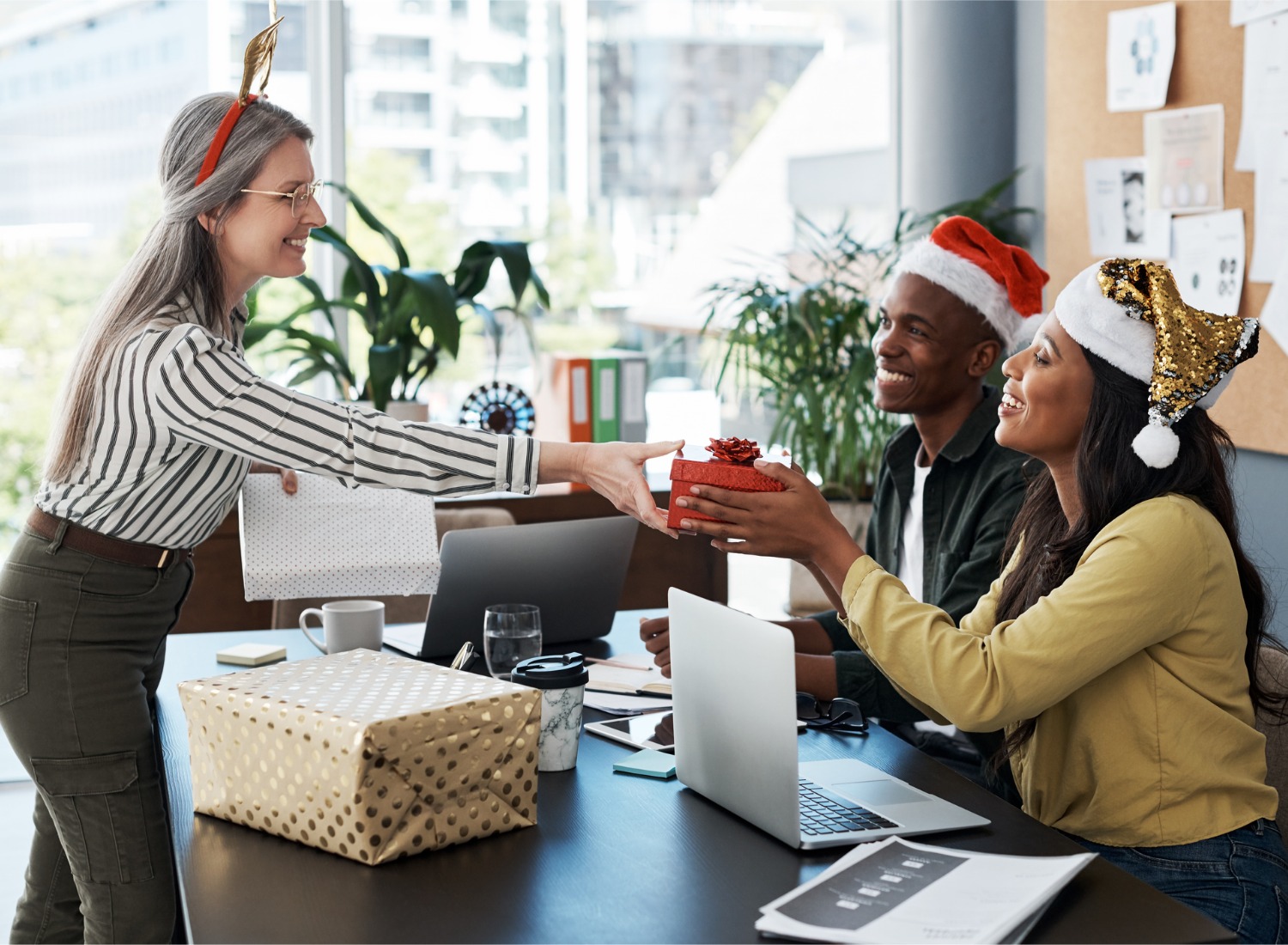 https://www.brit.co/reviews/wp-content/uploads/2023/11/shot-of-a-group-of-businesspeople-exchanging-christmas-gifts-in-a-modern-office.jpg_s1024x1024wisk20cfr4mT14P1Fpz2rgeg8jwgSQEIGFSYyFwCkBeJV4QiC8.jpg